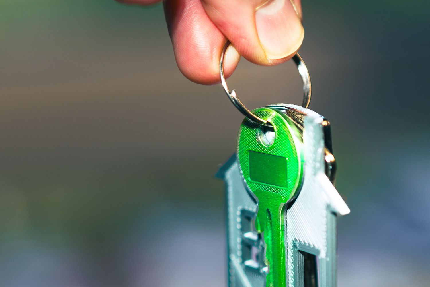 A hand holding a house keychain in sunlight, representing UK mortgage advice and home buying in 2026